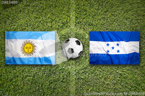 Image of Brazil vs. Honduras flags on soccer field
