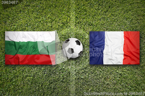 Image of Bulgaria vs. France flags on soccer field