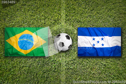 Image of Brazil vs. Honduras flags on soccer field