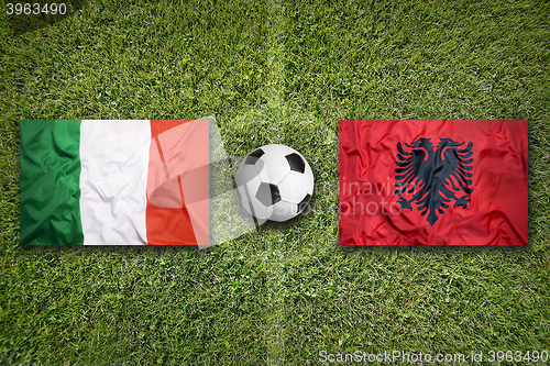 Image of Italy vs. Albania flags on soccer field