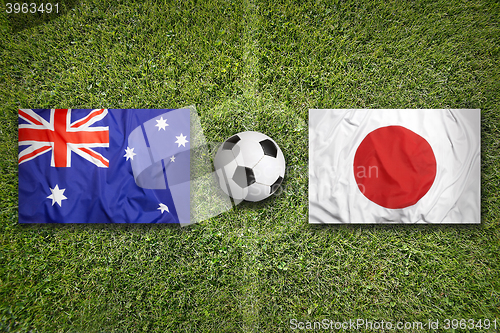 Image of Australia vs. Japan flags on soccer field