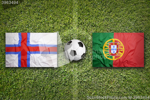 Image of Faeroe Islands vs. Portugal flags on soccer field