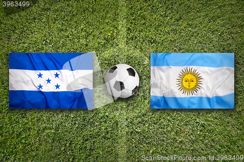 Image of Honduras vs. Argentina flags on soccer field