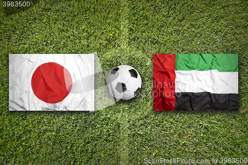 Image of Japan vs. United Arab Emirates flags on soccer field