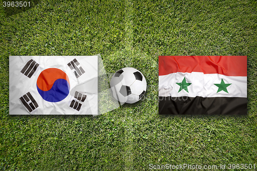 Image of South Korea vs. Syria flags on soccer field