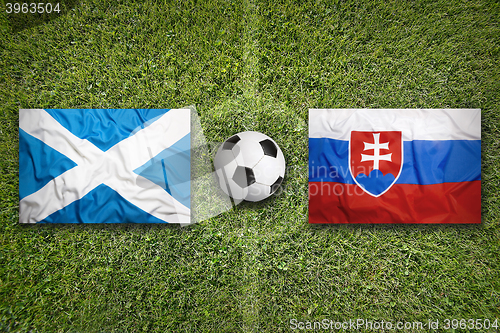 Image of Scotland vs. Slovakia flags on soccer field