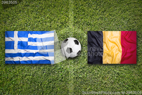 Image of Greece vs. Belgium flags on soccer field