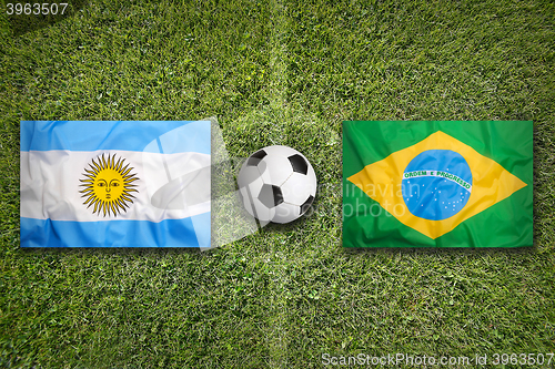 Image of Argentina vs. Brazil flags on soccer field