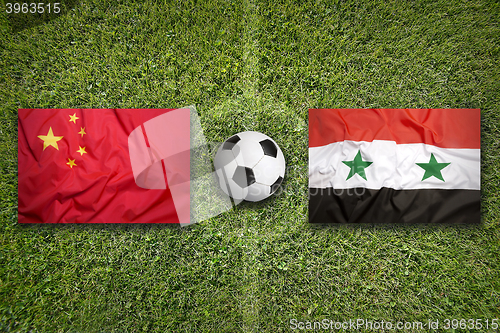Image of China vs. Syria flags on soccer field
