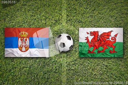 Image of Serbia vs. Wales flags on soccer field