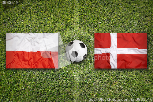 Image of Poland vs. Denmark flags on soccer field