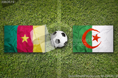 Image of Cameroon vs. Algeria flags on soccer field