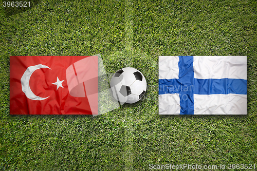 Image of Turkey vs. Finland flags on soccer field