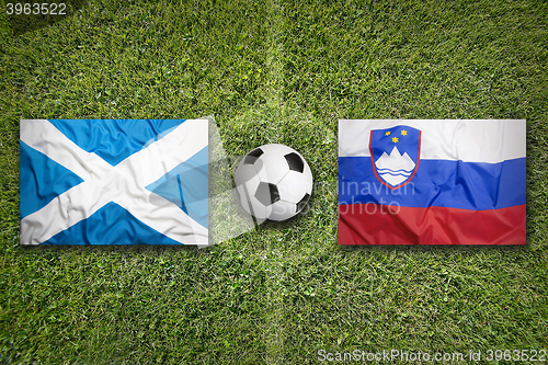 Image of Scotland vs. Slovenia flags on soccer field