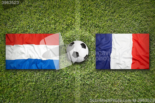 Image of Netherlands vs. France flags on soccer field