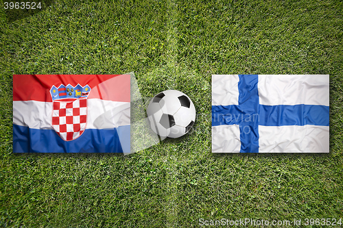 Image of Croatia vs. Finland flags on soccer field