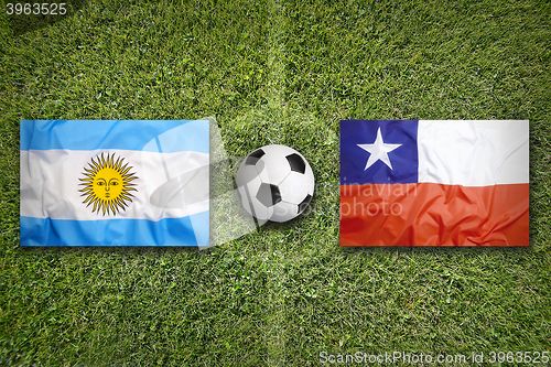 Image of Brazil vs. Chile flags on soccer field