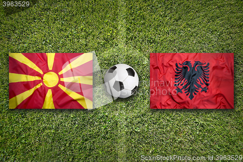 Image of Macedonia vs. Albania flags on soccer field