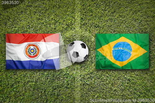 Image of Paraguay vs. Brazil flags on soccer field
