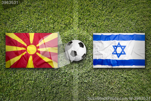 Image of Macedonia vs. Israel flags on soccer field