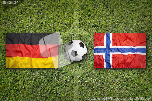 Image of Germany vs. Norway flags on soccer field