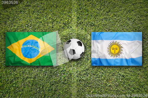 Image of Brazil vs. Argentina flags on soccer field