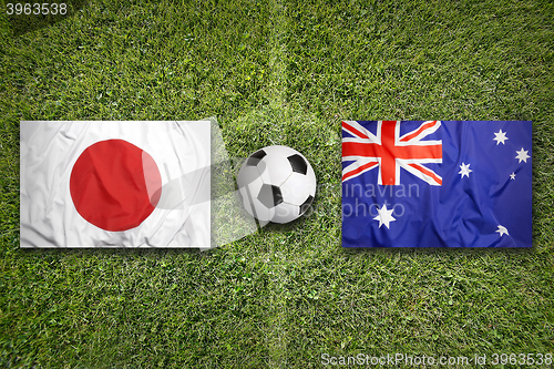 Image of Japan vs. Australia flags on soccer field