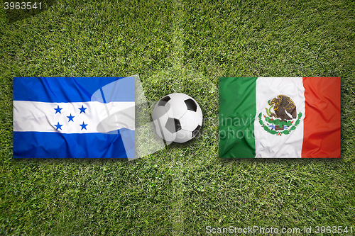 Image of Honduras vs. Mexico flags on soccer field