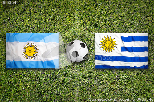 Image of Brazil vs. Uruguay flags on soccer field