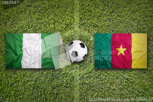 Image of Nigeria vs. Cameroon flags on soccer field
