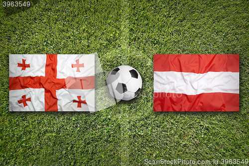 Image of Georgia vs. Austria flags on soccer field