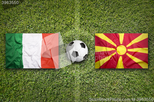 Image of Italy vs. Macedonia flags on soccer field