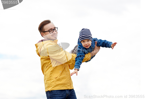 Image of father with son playing and having fun outdoors