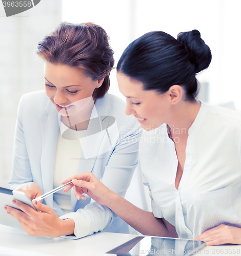 Image of business team working with tablet pc in office