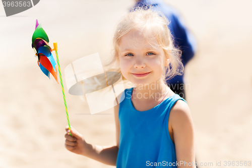 Image of happy little girl with colorful pinwheel at summer