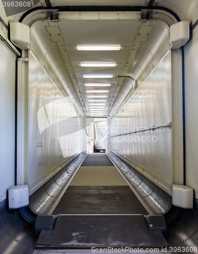 Image of Jetway, walking towards the plane, selective focus