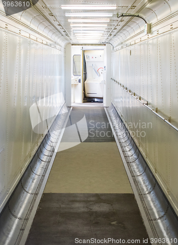 Image of Jetway, walking towards the plane, selective focus