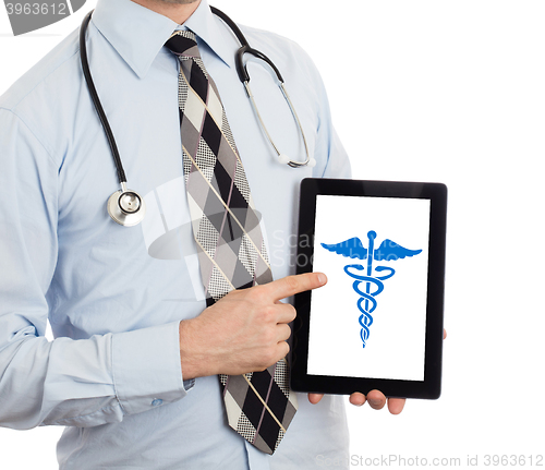 Image of Doctor holding tablet - Caduceus symbol