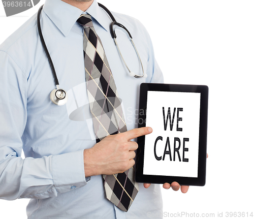 Image of Doctor holding tablet - We care