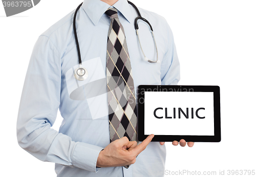 Image of Doctor holding tablet - Clinic