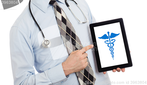 Image of Doctor holding tablet - Caduceus symbol