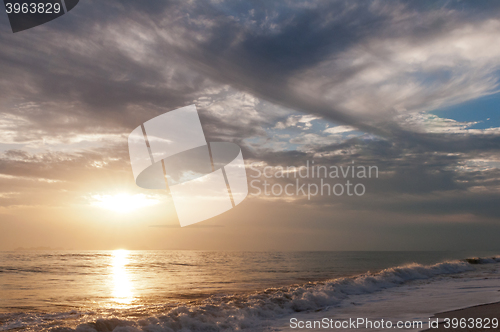 Image of Sunset over sea and cloudy sky