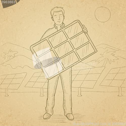 Image of Man holding solar panel.