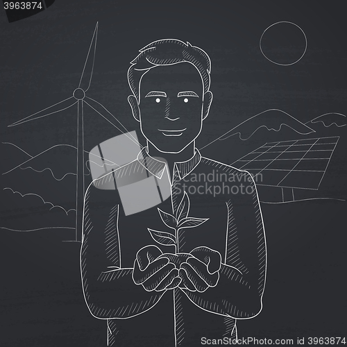 Image of Man holding plant.