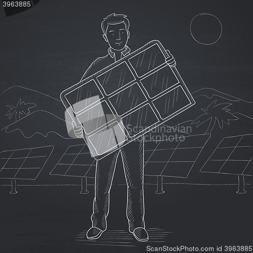 Image of Man holding solar panel.