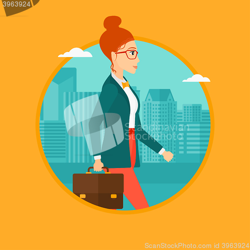 Image of Successful business woman walking with briefcase.