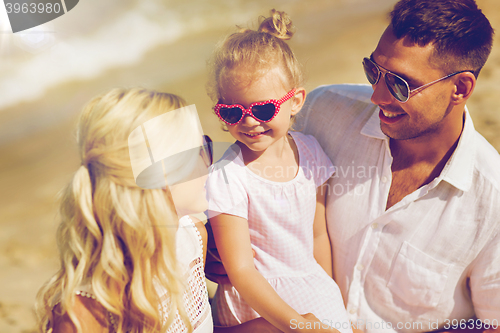 Image of happy family in sunglasses on summer beach
