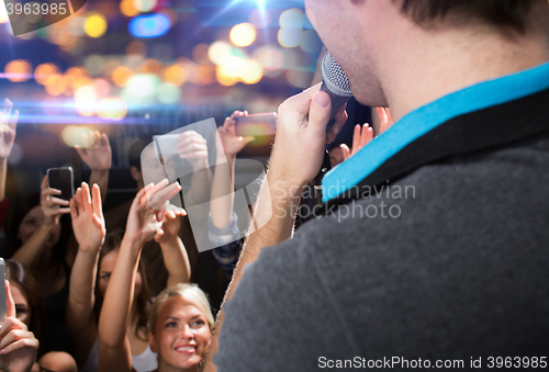 Image of close up of happy people at concert in night club