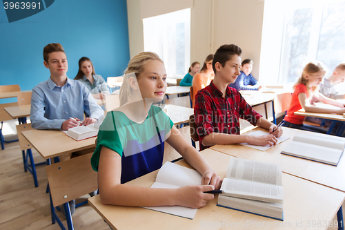 Image of group of students with books at school lesson