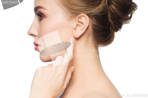 Image of beautiful woman pointing finger to her ear